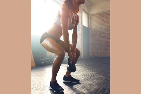 A women doing a kettlebell deadlift.