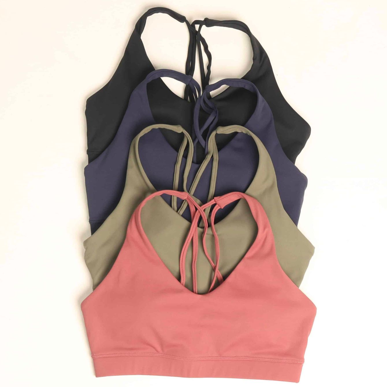 Qupia sports bra with compression fabric in black, navy, olive, and blush color ways.