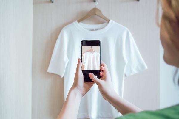 A personal trainer taking a picture of a t-shirt for their affiliate marketing side hustle.